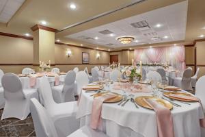 a banquet room with white tables and white chairs at Best Western PLUS Port O'Call Hotel in Calgary +154 photos