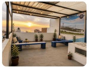 a patio with two blue benches and potted plants at Apto 3 dormitorios cerca al mar B in Pacasmayo