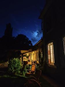 a bench sitting outside of a house at night at La Pépite in Sénac