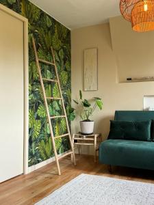 a living room with a green plant on the wall at La Pépite in Sénac