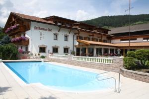 a large swimming pool in front of a building at Hotel Nussbaumerhof *** in Rodengo