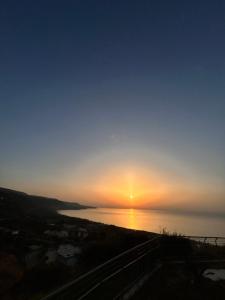 a sunset over a body of water at Medlar apartments in Zambrone +11 photos
