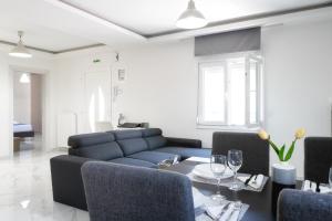 a living room with a couch and a table at Newly built detached house with parking 2 in Larisa