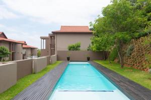 a swimming pool in the backyard of a house at Ballito Zimbali Wedge in Ballito