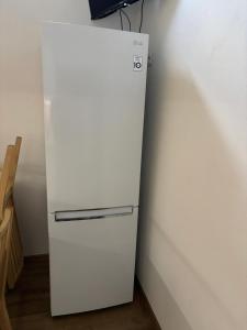 a white refrigerator in a corner of a room at Apartmán REBEKA in Holíč