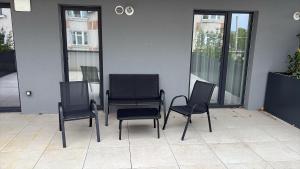 a group of chairs sitting next to a building at Urban Elegance in Cluj-Napoca
