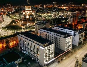 an aerial view of a city at night at Mabelle Gold Stay in Baia Mare