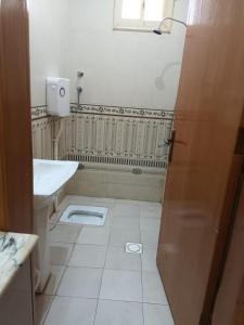 a white bathroom with a sink and a toilet at افاق in Khamis Mushayt