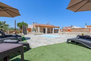 a backyard with a swimming pool and a house at Olea holiday house in Astérion
