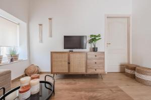 a living room with a tv on a dresser at Olea holiday house in Astérion