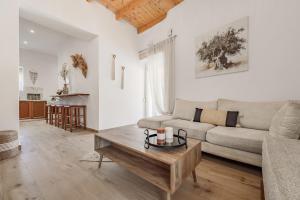 a living room with a couch and a coffee table at Olea holiday house in Astérion
