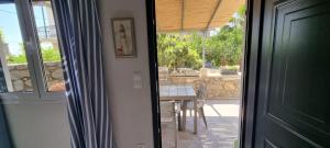 a door leading into a dining room with a table at Lemnos Nest in Kondiás