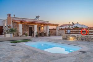 a swimming pool in front of a house at Olea holiday house in Astérion