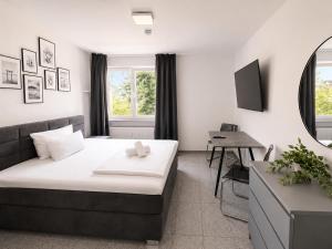 a hotel room with a bed and a desk at Lipp Apartments in Cologne
