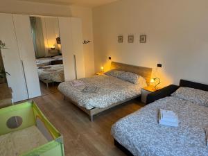 a hotel room with two beds and a mirror at Residence Ai Melograni in Silea +6 photos