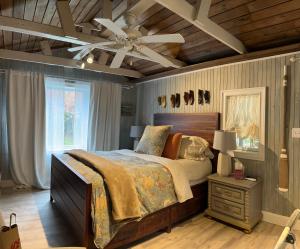 a bedroom with a bed and a ceiling fan at Frederick William House in Falmouth +110 photos