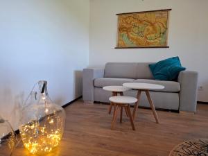 a living room with a couch and two tables at Mecsek Vendégház in Mecseknádasd