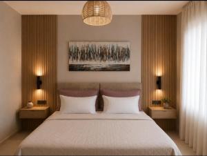 a bedroom with a large bed with two night stands at Chara’s Luxury home in Kalabaka