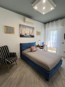 a bedroom with a large bed and a chair at La Base Fitness House in Decimomannu +55 photos