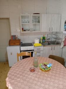 a kitchen with a table with a pink table cloth on it at Centar in Valjevo