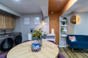 a kitchen with a table with a vase of flowers on it at VIBES! Free Parking, Piano, King Bed in Washington, D.C.
