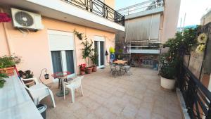 an apartment patio with chairs and tables and a balcony at Dream Home in Sparta