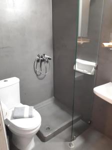 a bathroom with a shower with a toilet and a sink at Helena Apartments in Paralia Panteleimonos