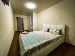 a bedroom with a large bed with two pillows at Апартаменти ТЦ Галактика in Kremenchuk +8 photos