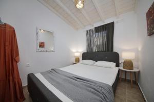 a bedroom with a bed with two pillows on it at VILLA VICTORIA in Ditropo +36 photos