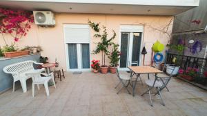 a patio with a table and chairs and plants at Dream Home in Sparta