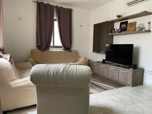 a living room with a couch and a flat screen tv at Quiet and Lovely Residence in St. Julianʼs