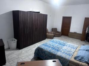 a bedroom with a bed and a wooden cabinet at Quiet and Lovely Residence in St. Julianʼs +6 photos
