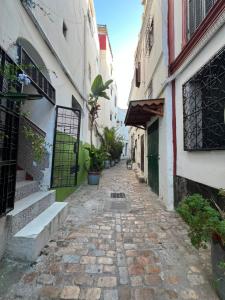 an alley in an old town with buildings at Bab Rmouz apartment in Tétouan