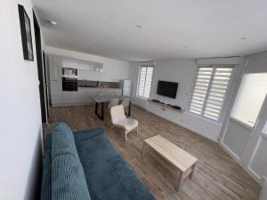 a living room with a couch and a table at Le cocon Portelois in Le Portel