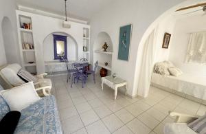 a living room with a couch and a table at Seafront House, Private Beach, Sunset View, Diliso in Vathírrevma