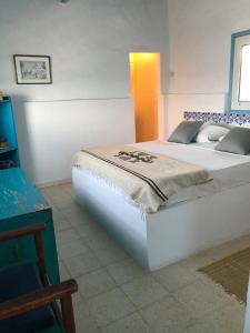 a bedroom with a large white bed in a room at El Baraka in Houmt Souk