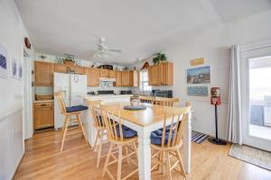 a kitchen with a table and chairs and a refrigerator at 7630 - Obx Box in Avon