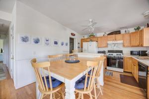 a kitchen and dining room with a table and chairs at 7630 - Obx Box in Avon