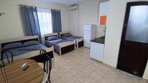 a small room with two beds and a kitchen at ℰ`ℋ Hotel - Velipoje rruga nr 7 in Velipojë