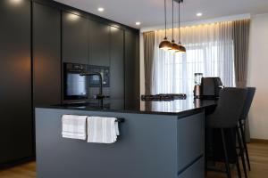 a kitchen with a island with a counter top at Lumy Housing in Pärnu