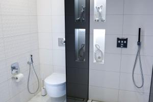 a bathroom with a toilet and a shower stall at Lumy Housing in Pärnu +13 photos