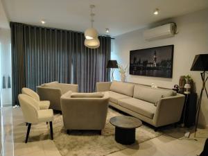 a living room with a couch and two chairs at Villa 80 in Gonapola