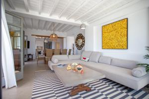a living room with a couch and a table at South Star private Villa in Mikonos