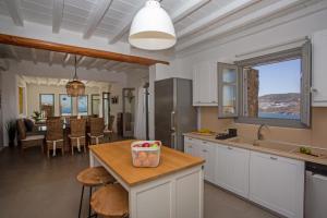 a kitchen with a table with a bowl of fruit on it at South Star private Villa in Mikonos