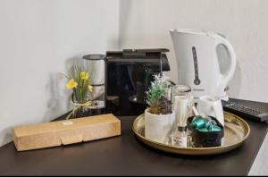 a table with a coffee maker on top of it at Hotel Knurrhahn DZ in Wilhelmshaven +3 photos