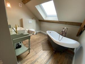 a bathroom with a large bath tub and a sink at B&B Tierlantijn in Hamont