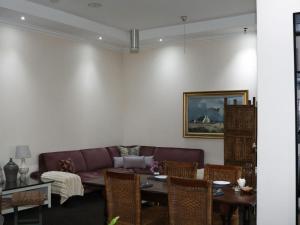 a living room with a couch and a table at 12 On York Guesthouse in Bloemfontein