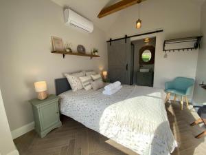 a bedroom with a large bed and a blue chair at B&B Tierlantijn in Hamont