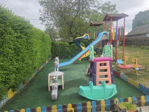 a playground with a slide in a yard at Casa Flavia in Mahmudia