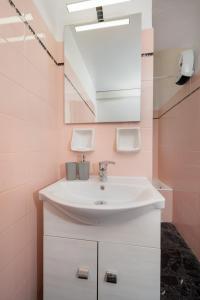 a bathroom with a sink and a mirror at Porto Marina SeaView in Porto Rafti +11 photos